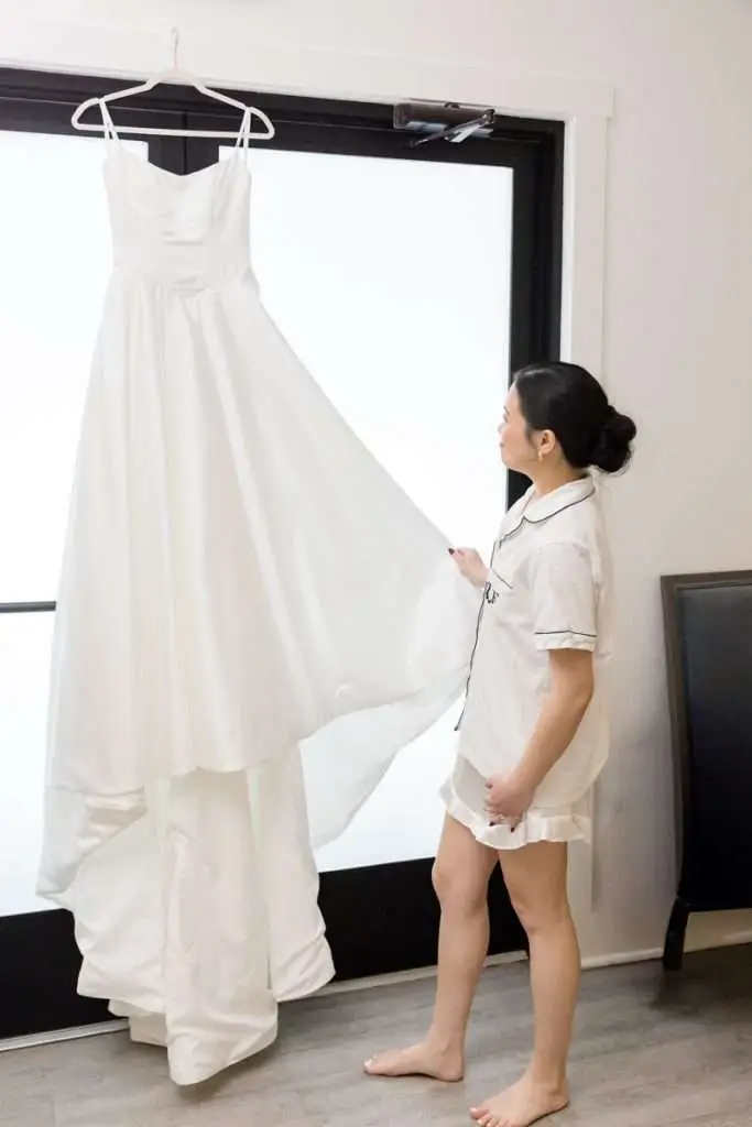 bride looks at dress, The Ivy House, Kalamazoo wedding photographer
