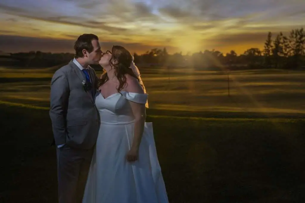 couple kissing, golden hour, macatawa golf club