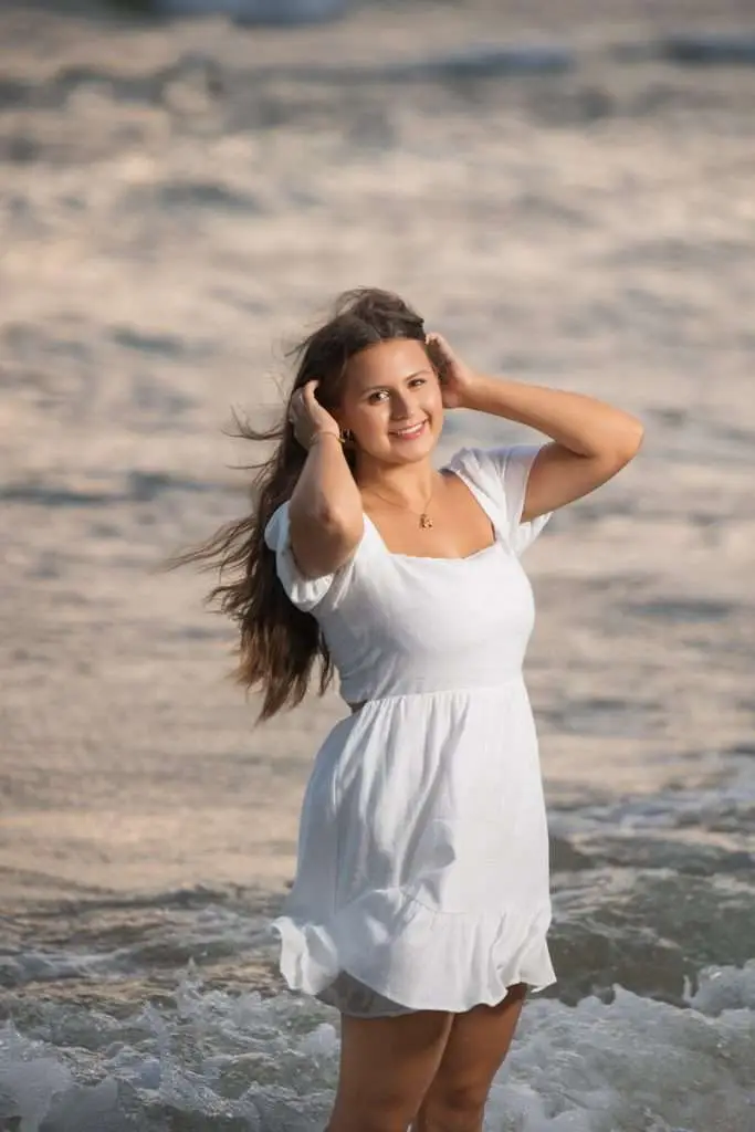 Senior girl on the beach walking in golden hour