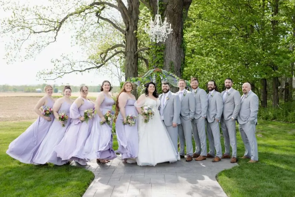 Bridal party under tree at Vintage Rose Barn
