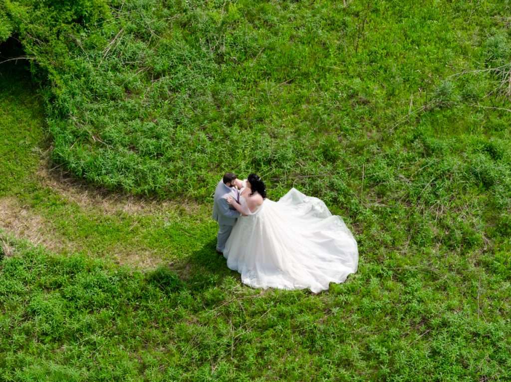 Couple dancing in field at Vintage Rose Barn
