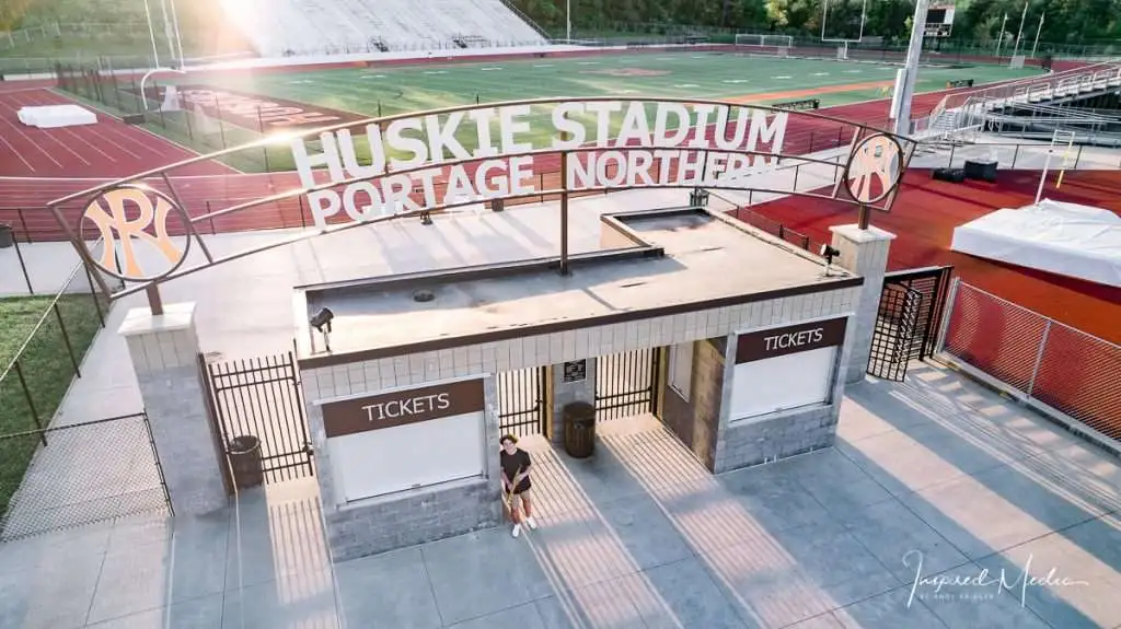 Kalamazoo high school senior posing at Huskie Stadium at Portage Northern High School during a senior photo session