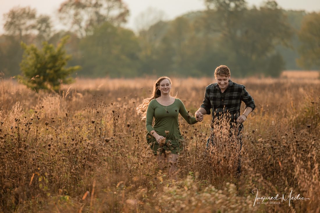 Golden hour engagement photos in a field