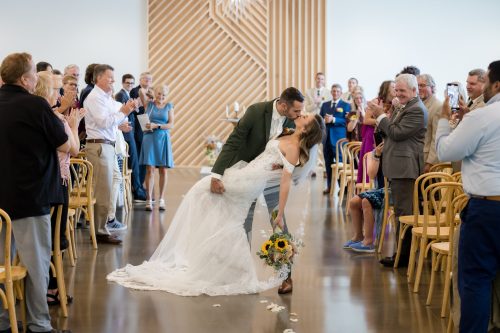Bride and Groom do a dip kiss at Leona Rd Wedding Venue in Grand Rapids