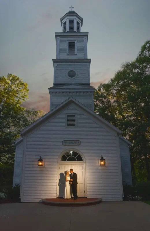 Couple in front of chapel during golden hour at Morris Estate